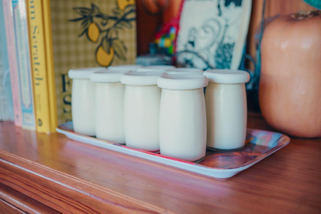 Pot set homemade yogurt in little glass jars on the kitchen hutch