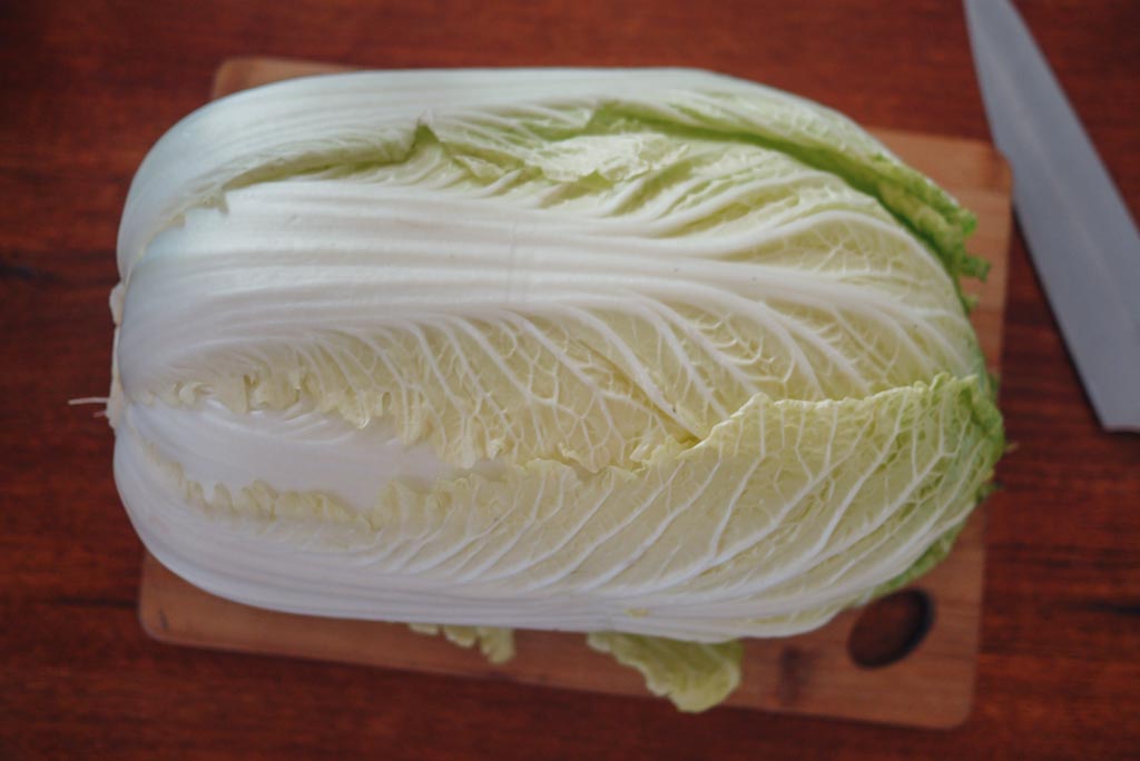 Napa cabbage on cutting board and knife