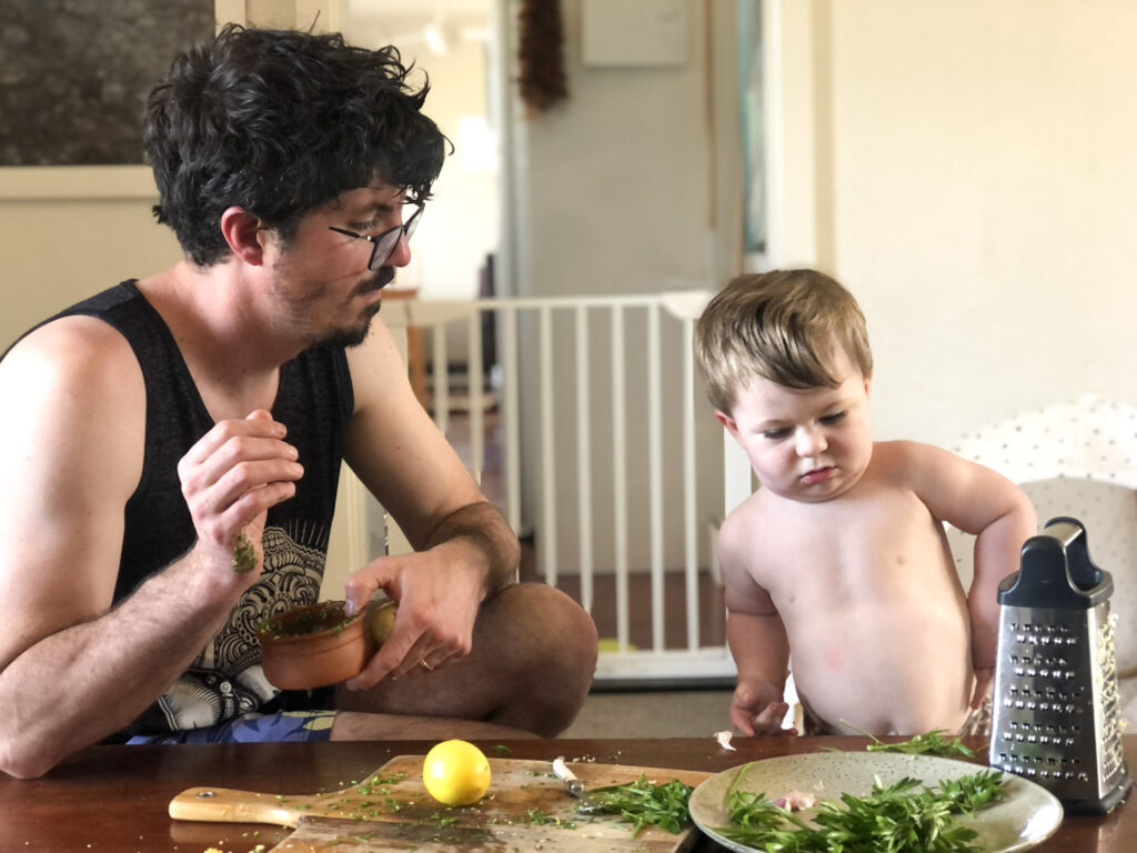 A dad and his 18-month-old son preparing gremolata for osso bucco.